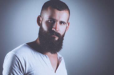 Obraz premium Portrait of handsome man standing, isolated on grey background