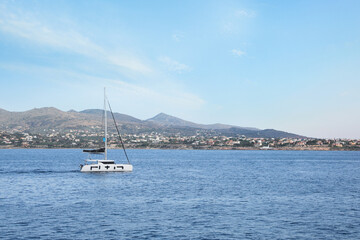Fototapeta premium Beautiful view of sea with boat and distant coastal city