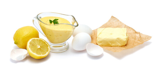 Tasty yellow hollandaise sauce in glass bowl gravy boat isolated on white background