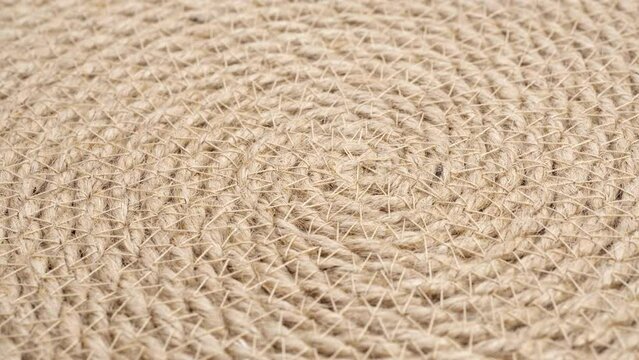 Jute braided spiral rug texture background clos-up.