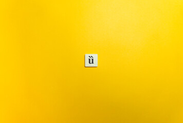 Double Grave Diacritical Mark on Letter Tile on Yellow Background. Minimal Aesthetics.