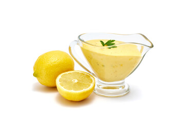 Tasty yellow hollandaise sauce in glass bowl gravy boat isolated on white background