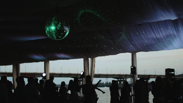 Silhouette of people dancing on the party, unrecognizable people having fun slow motion shot.