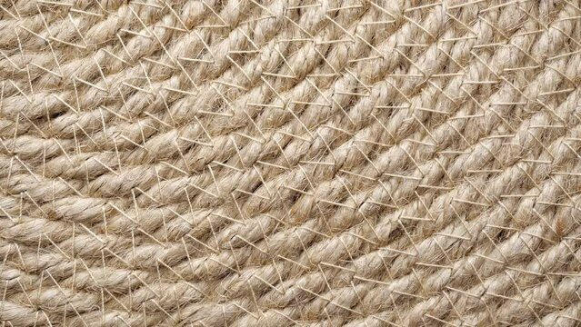 Jute braided spiral rug texture background clos-up.