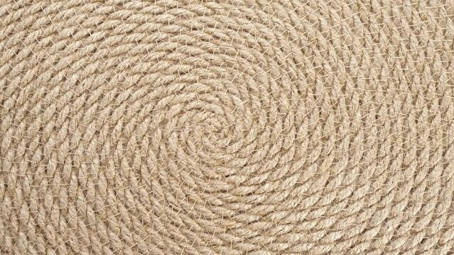 Jute braided spiral rug texture background clos-up.