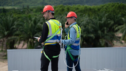 Construction workers clean solar panels for energy.Renewable Energy Battery Clean Mountain Climber...