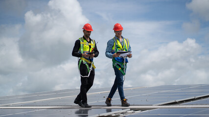 Construction workers clean solar panels for energy.Renewable Energy Battery Clean Mountain Climber Activities Work Uniforms.Managers discuss electric power ecology, human, renewable energy.
