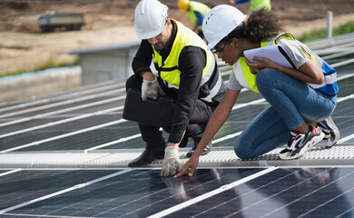 Engineers, males  inspecting solar panels on the roof, inspecting safety and cleaning services. Construction industry, construction personnel
