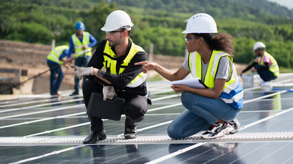 Engineers, males  inspecting solar panels on the roof, inspecting safety and cleaning services. Construction industry, construction personnel
