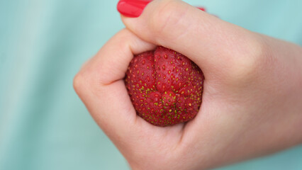 Clenched strawberries in fist in form of constipation of colon