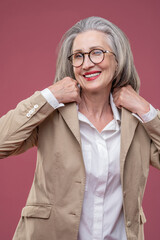 Woman in light jacket standing and looking confident