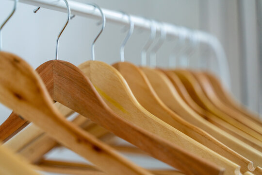 Close-up of wardrobe with wooden clothes hanger,
