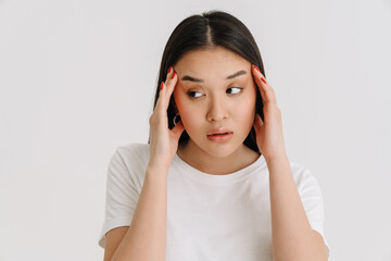 Asian young woman with headache rubbing her temples