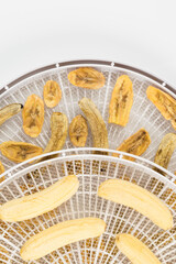 ready and fresh bananas in drying trays, top view