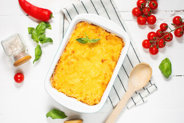 Delicious homemade italian Lasagna with bachamel sauce in the oven in a ceramic dish. top view