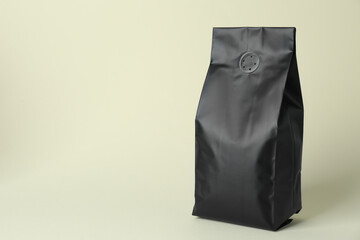 One blank foil package on beige background. Space for text