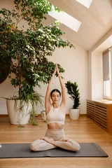 Foto auf Acrylglas Young white woman doing exercise on mat during yoga practice © Drobot Dean