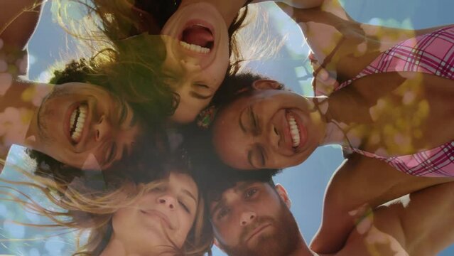 Composite video of low angle view of diverse group of friends smiling against tall trees