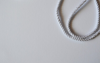 White rope cord silky silver textile tie curved lasso line background 