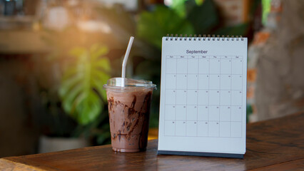 Calendar 2022 desk place on the table. Desktop Calender for Planner to plan agenda, timetable, appointment, organization, management each date, month, and year on wooden office table. Calendar Concept