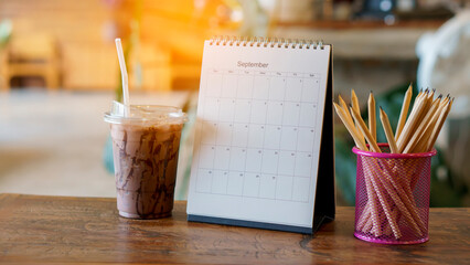 Calendar 2022 desk place on the table. Desktop Calender for Planner to plan agenda, timetable, appointment, organization, management each date, month, and year on wooden office table. Calendar Concept