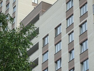 Full-color horizontal photo. Linear geometric composition. An inanimate landscape of parts of the facades of city buildings.