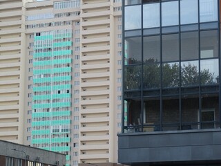 Full-color horizontal photo. Linear geometric composition. An inanimate landscape of parts of the facades of city buildings.