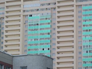 Full-color horizontal photo. Linear geometric composition. An inanimate landscape of parts of the facades of city buildings.