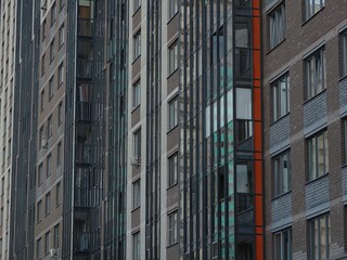 Full-color horizontal photo. Linear geometric composition. An inanimate landscape of parts of the facades of city buildings.
