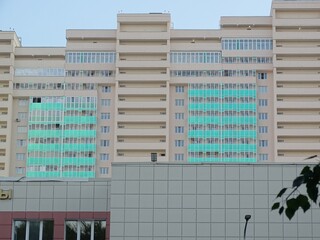 Full-color horizontal photo. Linear geometric composition. An inanimate landscape of parts of the facades of city buildings.
