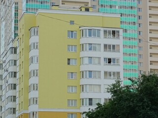 Full-color horizontal photo. Linear geometric composition. An inanimate landscape of parts of the facades of city buildings.