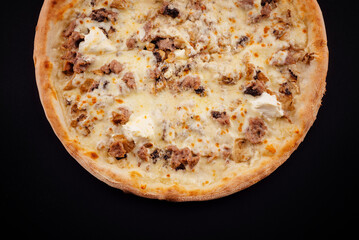 Tasty pizza with fresh ingredients on black