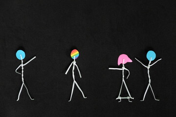 LGBT or LGBTQIA bullying, insult and harassment, discrimination and homophobia concept. Human stick figure in dark black background creative composition. - obrazy, fototapety, plakaty