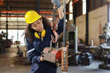 Technician engineer or worker woman in protective uniform with safety hardhat standing and...