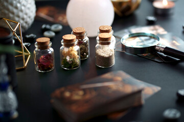 Blurred mystic rituals and fortune telling with vintage esoteric magic objects tarot cards on witch...