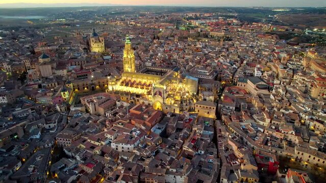 Aerial evening view of Toledo, Spain. Flying over Toledo with citylights after sunset in Castilla-La Mancha.