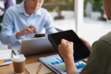 Asian young business people discussing on performance revenue in meeting. businessman working with co-worker team. financial adviser analyzing data with investor.