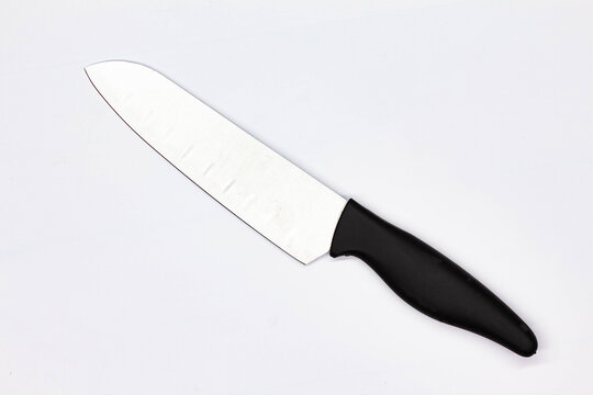 Kitchen knife for meat on white background. Chef Butchers knife for Cutting Meat. Boning knife for cutting raw meat. Kitchenware. Professional food preparation. Close-up. Top view. Isolated