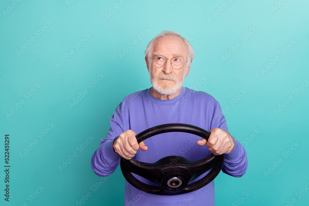 Sticker portrait of handsome minded person hands hold wheel look interested empty space isolated on teal col