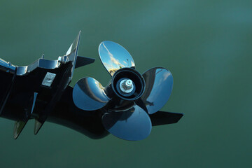 Black Four-bladed boat motor propeller.
