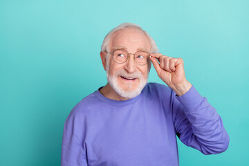 Obraz premium Portrait of positive minded person hand touch glasses look interested empty space isolated on teal color background