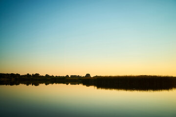 Fototapeta na wymiar Sunset over a rural river