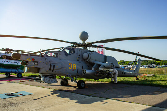 Russian attack helicopter Mi-28N "Night Hunter" (NATO-Havoc) with gun ammunition laid out in front of helicopter. Static parking MAKS-2011. Close-up. Zhukovsky, Russia - August 17, 2011