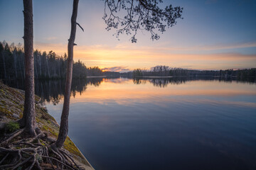 Beautiful sunset in tranquil lake at summer evening in Finland - 522456462