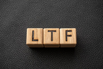 LTF - acronym from wooden blocks with letters, abbreviation LTF Long Term Equity Mutual Fund and RMF Retirement Mutual Fund concept, gray background