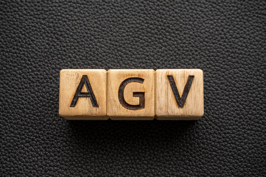 AGV - acronym from wooden blocks with letters, abbreviation AGV automated guided vehicle concept, gray background