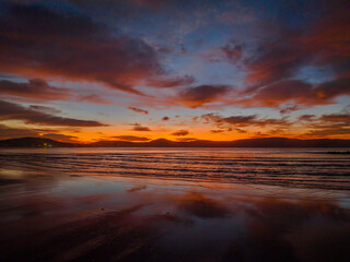 Winter sunrise at the seaside with high cloud and reflections