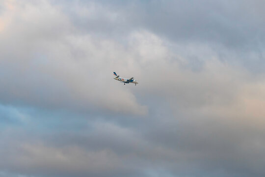 Rex Regional Express Airliner In The Early Evening Cloud Filled Sky