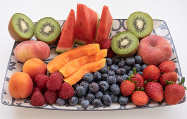 Close-up on fresh organic summer colorful fruit - healthy food in white background, healthy eating concept - copy space