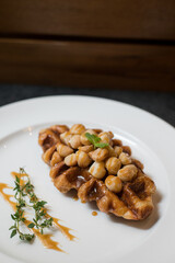 Croffle is a combination of croissant and waffle. This croffle served on a white plate 